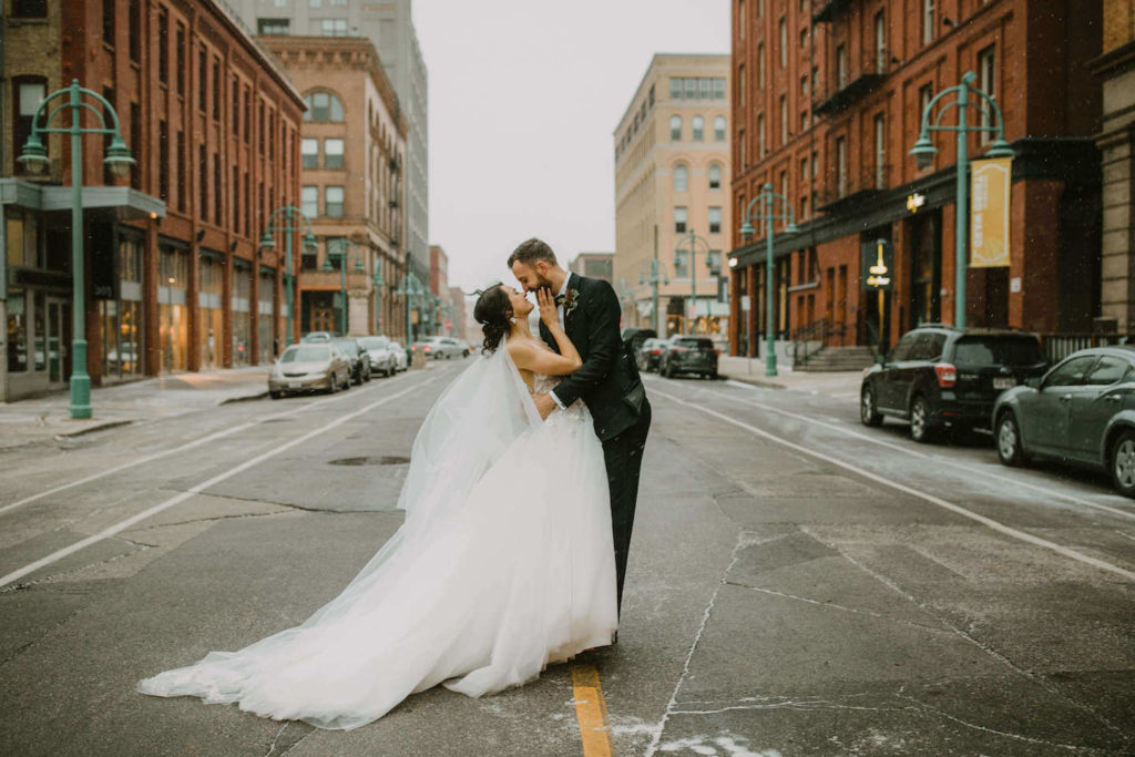 Bride and Groom in downtown Milwaukee looking at each other during their winter wedding.