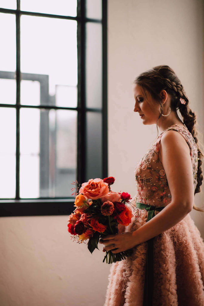Bride looking down at her bouquet at The Tinsmith in downtown Madison, Wisconsin. 