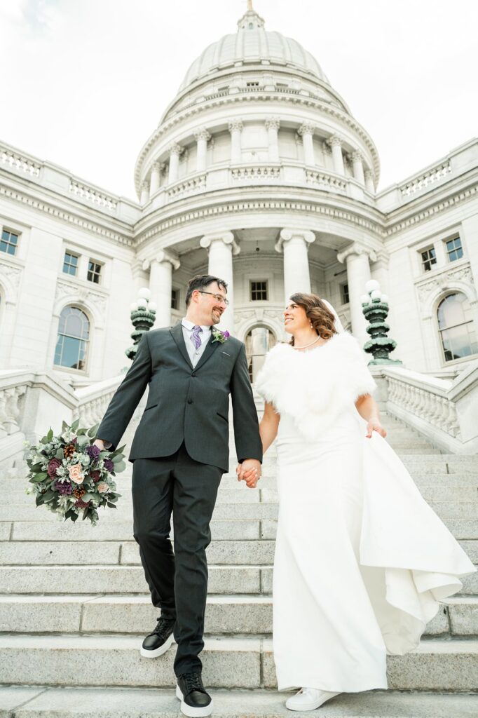 bride and groom walking down steps by wedding coordinator madison wi