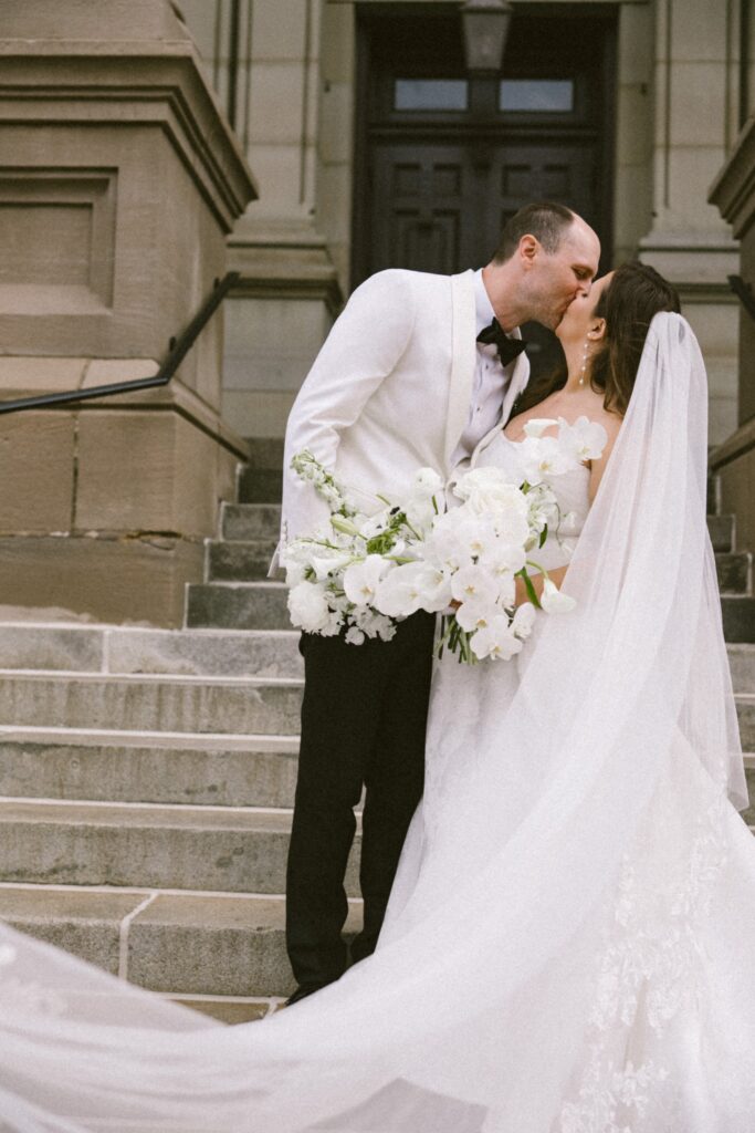 wedding couple kissing on stairs at best wedding venues in milwaukee