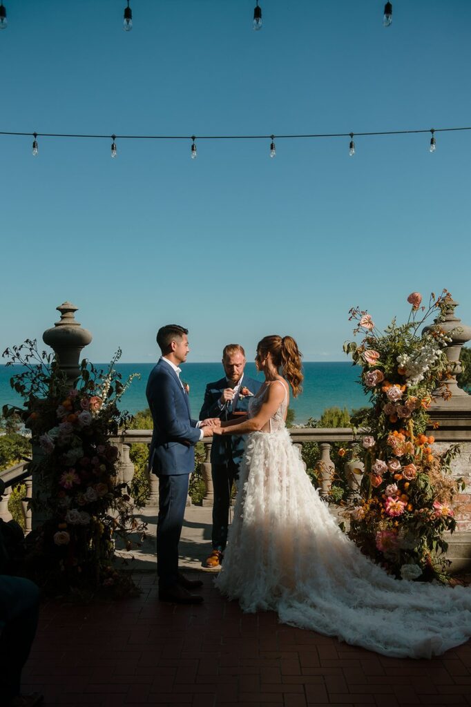 couple holding hands during ceremony at wedding venues in milwaukee