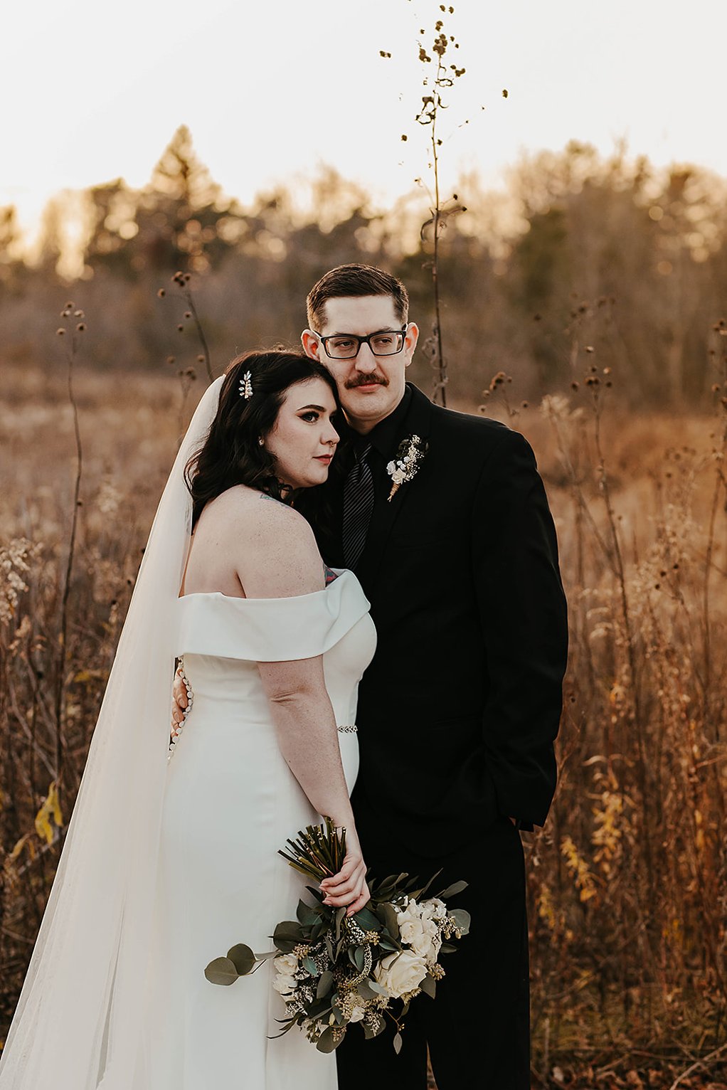 Couple posing at their dream outdoor wedding venue