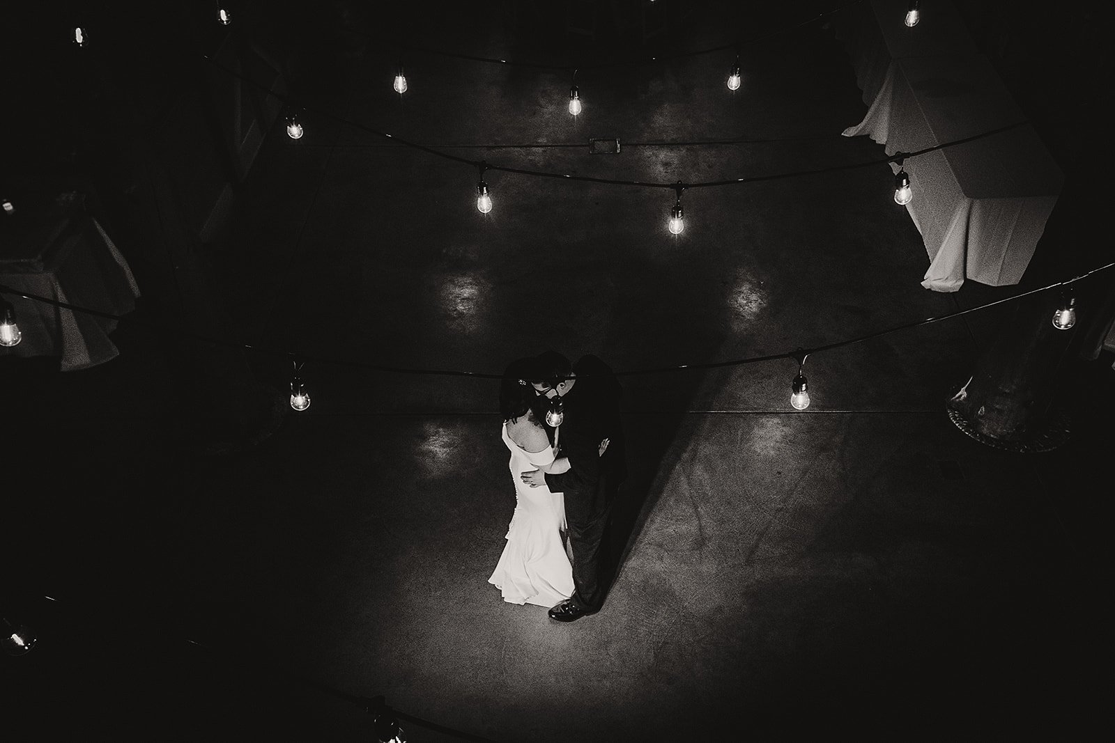 bride and groom dancing under the lights at their outdoor wedding venue in milwaukee wi