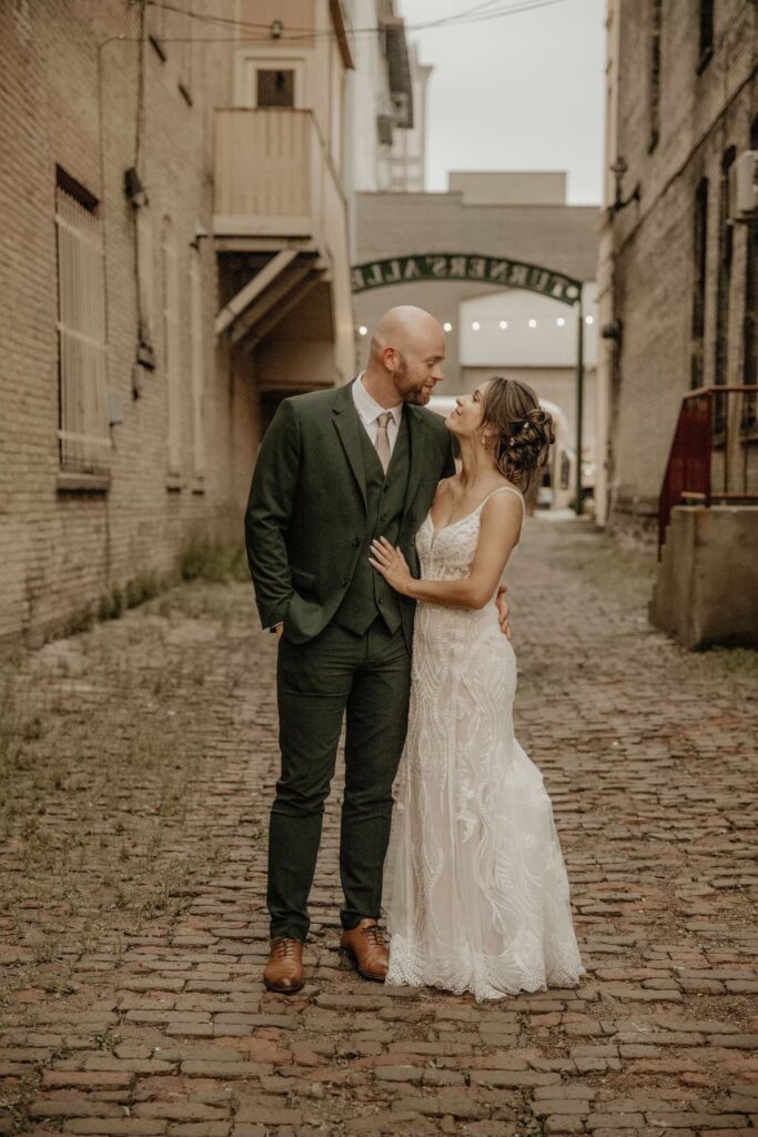 Couple gazing at each other outside of their wedding venue