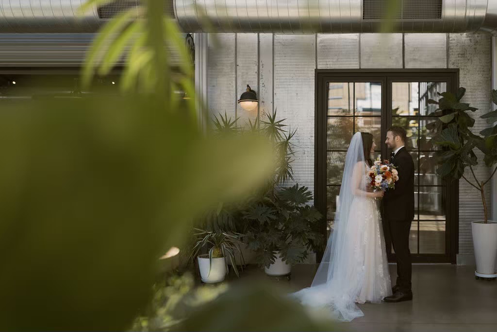 Lush indoor garden wedding venue with married couple