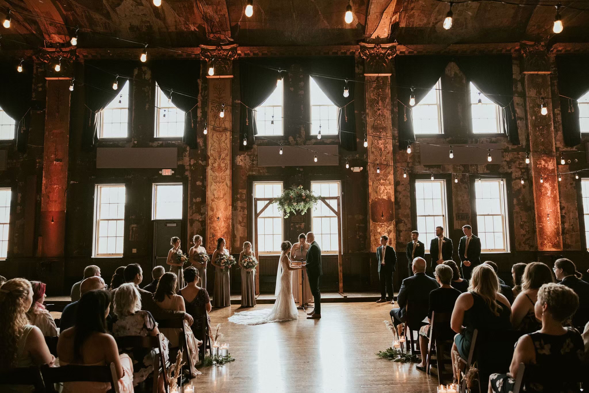 Couple standing at alter indoor wedding venue