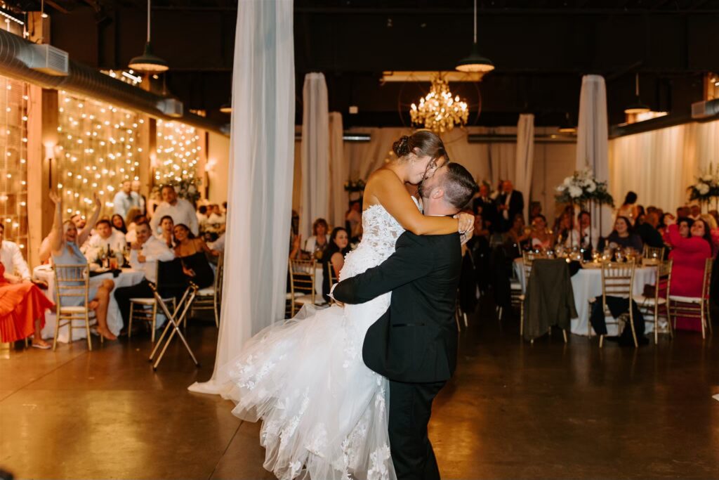 married couple , first dance kiss at the reception