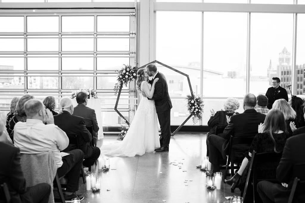 Couple kissing at the alter at indoor wedding ceremony in Milwaukee