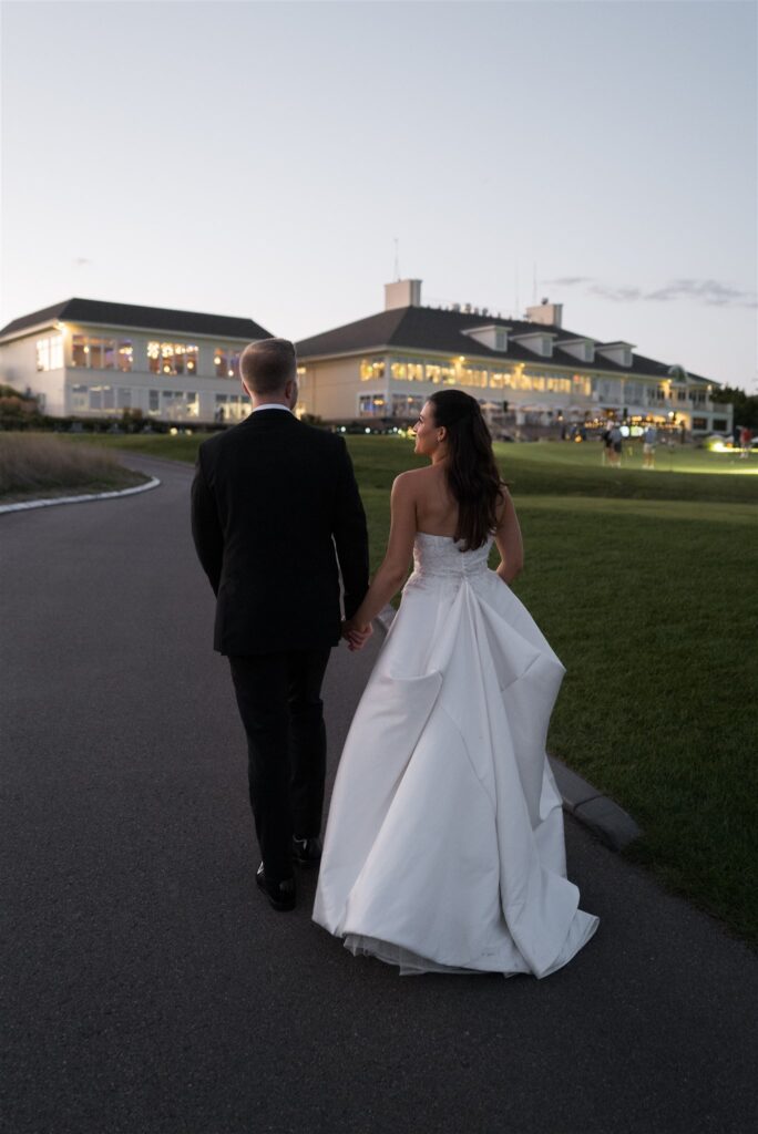 bride and groom walking towards their lake geneva wedding venue