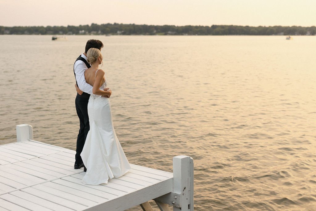 bride and groom gazing at the sunsent over lake geneva at their lake geneva wedding