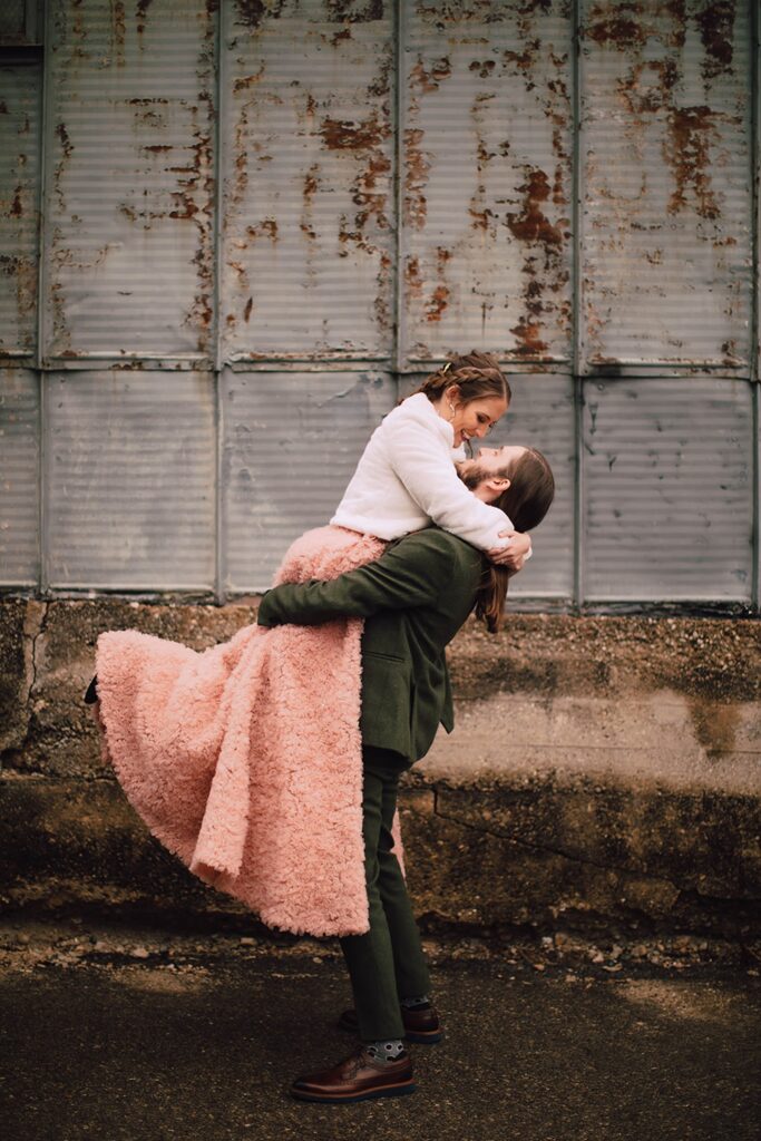 Wedding couple celebrating together outside an industrial wedding venue in Madison