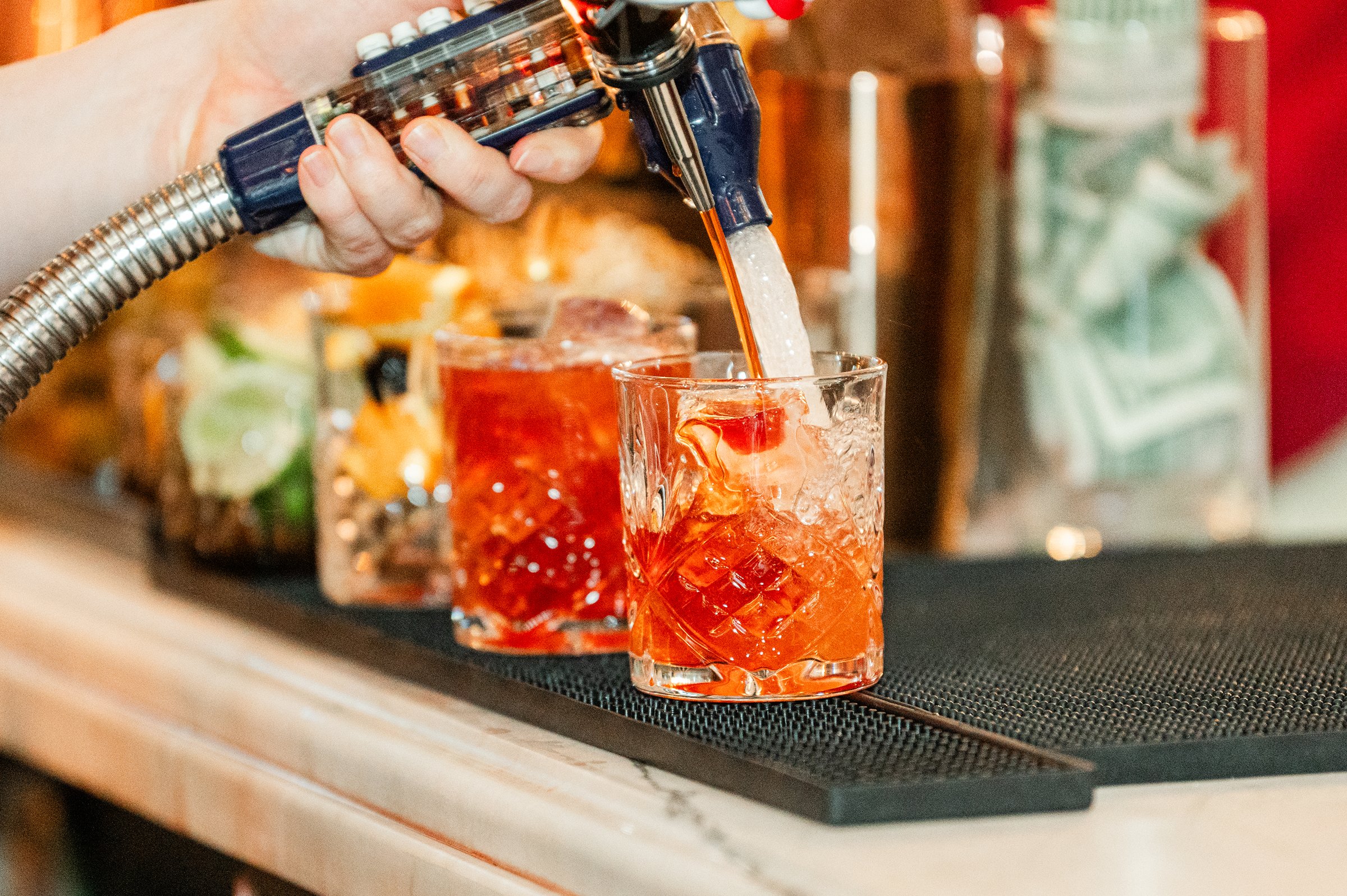 Bartender pouring signature cocktails during a wedding reception at one of the most stylish wedding venues in Madison