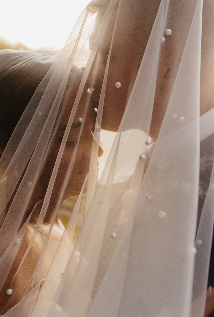 Close-up of bridal veil flowing in the sunset light during a Madison wedding