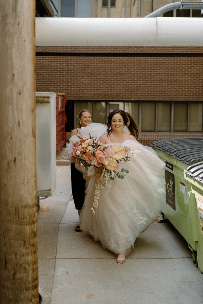 Professional wedding planner Liz from Dream Weddings WI guiding the bride behind the scenes on her wedding day