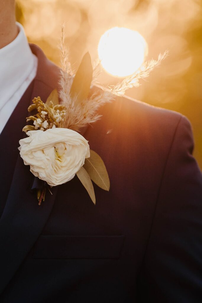 Groom’s boutonniere photographed at sunset during a Madison, Wisconsin wedding