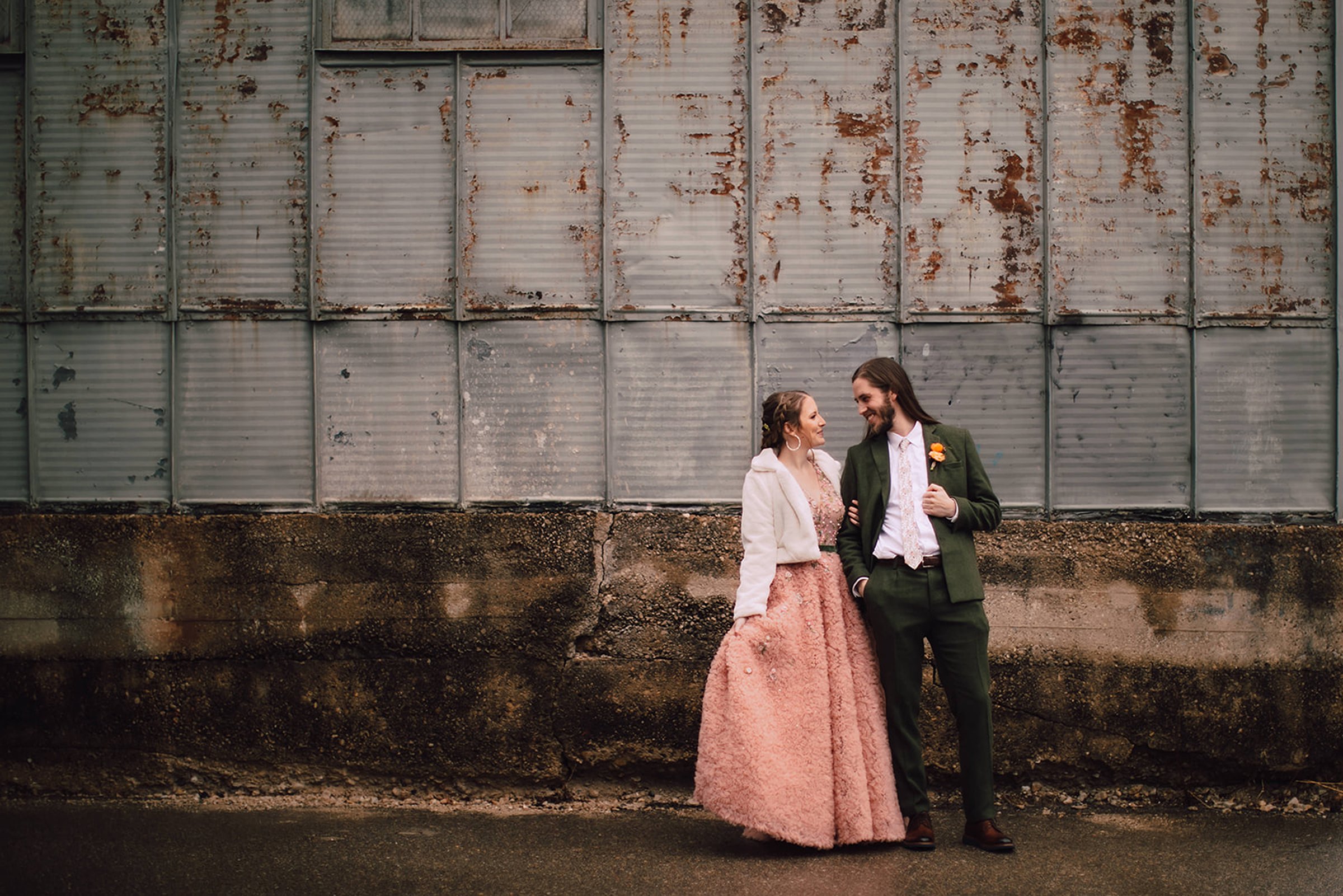 Wedding couple walking together outside one of the most unique wedding venues in Madison WI